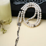 A 99-bead rosary made of natural farm-grown pearls.