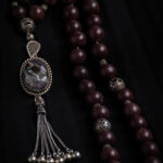 A rosary made of reddish-brown jade stone.